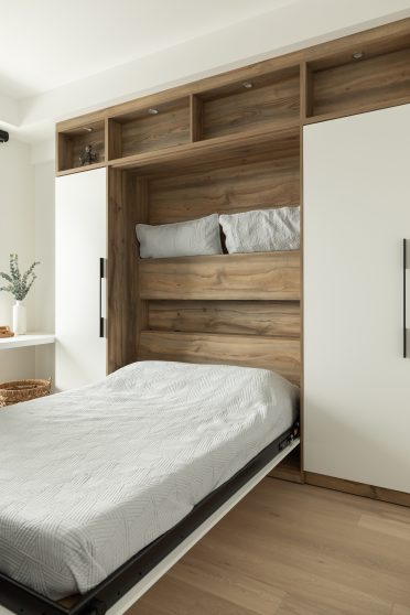 Lit escamotable sur mesure Limuro en bois et blanc, combinant espace de rangement intégré, éclairage encastré et design contemporain.